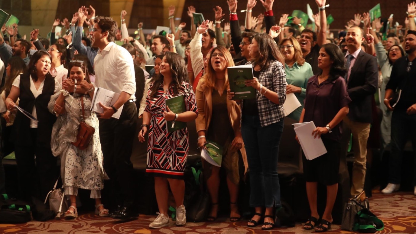 Audience standing and cheering at a live event