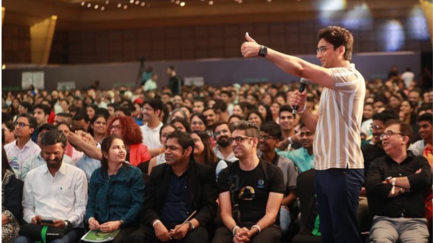 Tauseef Hasan speaking to a packed auditorium